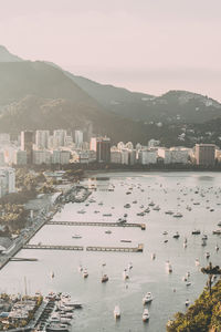 High angle view of city by sea against sky