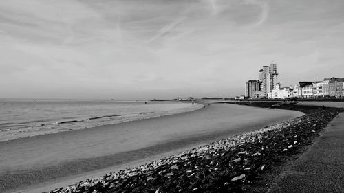 View of beach against cloudy sky