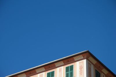 Low angle view of building against clear blue sky