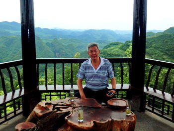 Portrait of myself sitting on mountain having chinese tea.