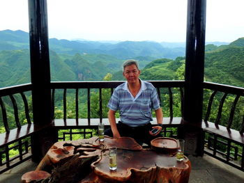 Portrait of a young man sitting on mountain