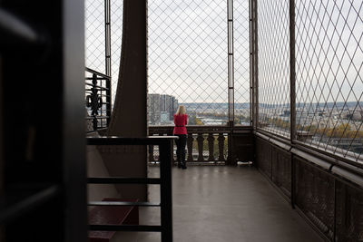 Woman standing by railing