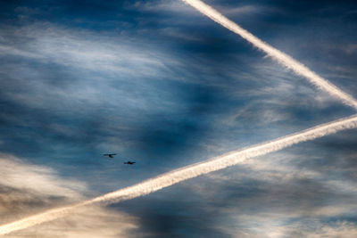 Low angle view of vapor trails in sky