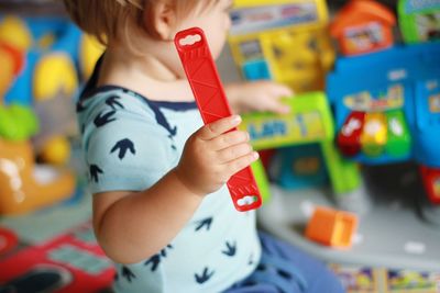 Cute girl playing with toy toys