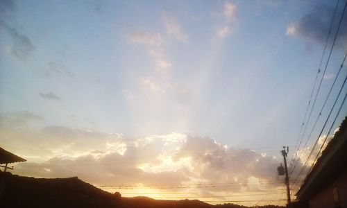 Low angle view of silhouette mountains against sky