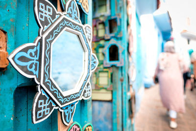 Rear view of woman with graffiti on wall