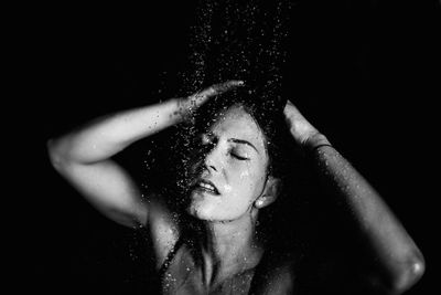 Mid adult woman taking shower in bathroom