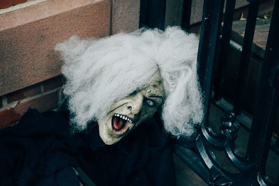 Close-up portrait of person wearing spooky mask