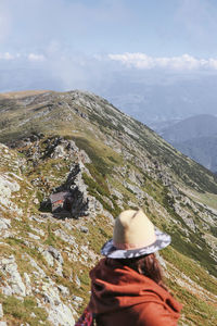 Woman looking at mountain against sky
