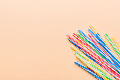 High angle view of multi colored pencils on table against white background