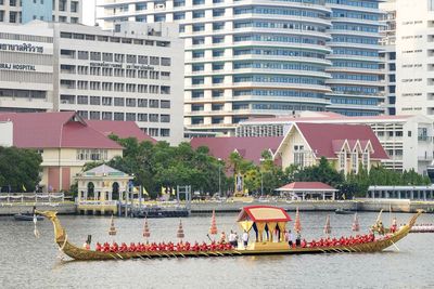 Buildings by river in city