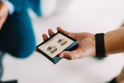 Close-up of hand holding clock