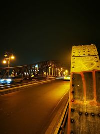 Illuminated light trails on road against sky at night