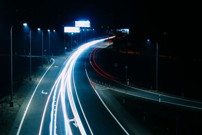 Light trails on road in city at night