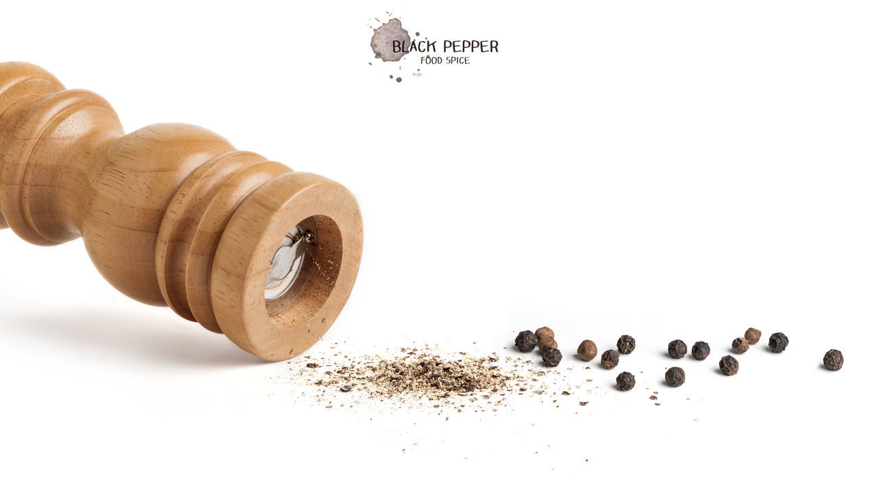 CLOSE-UP OF COFFEE BEANS IN WHITE BACKGROUND