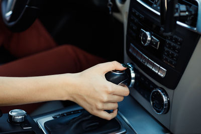 Cropped hands of man holding steering wheel