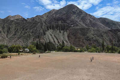 View of desert against cloudy sky