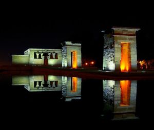 Reflection of illuminated building in water at night