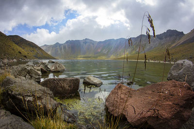 Scenic view of lake and mountains against sky