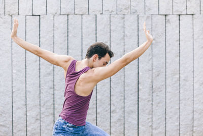 Low angle view of man with arms outstretched