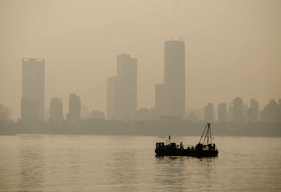 Boats in sea against clear sky in mumbai near bandra worli sea link