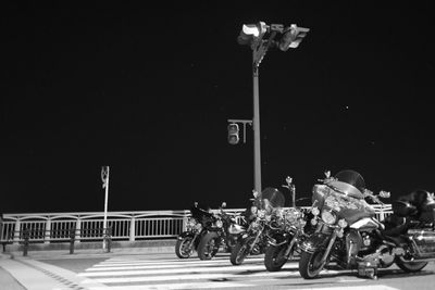 People at illuminated street lights at night