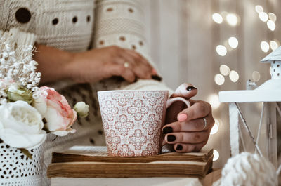 Midsection of woman holding flower bouquet