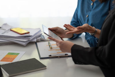 Midsection of businessman working on table