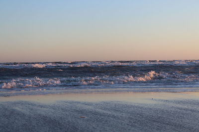 Scenic view of sea against clear sky during sunset