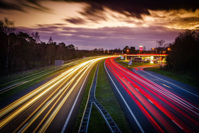 High angle view of light trails on highway at night