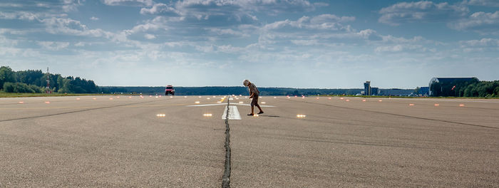 View of boy on airport runway