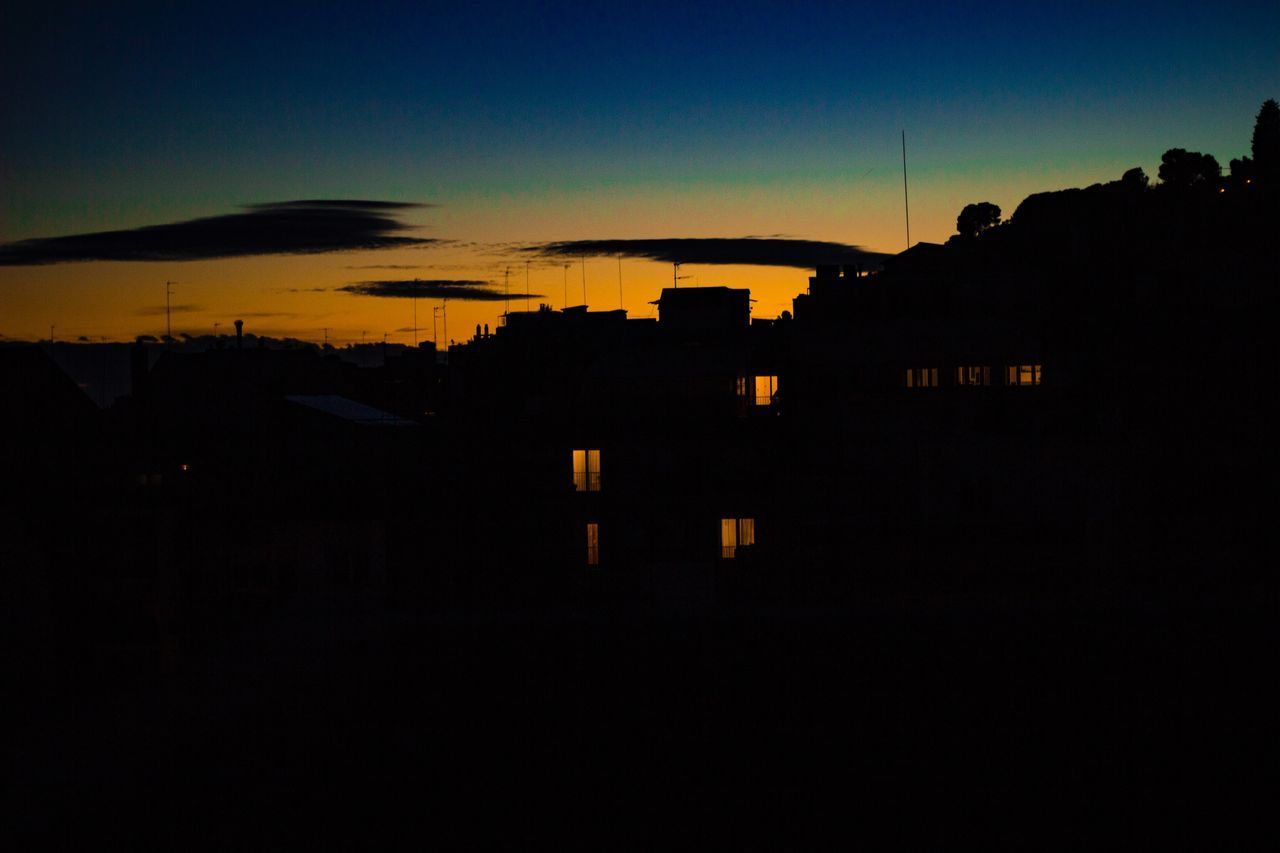 SILHOUETTE BUILDINGS AGAINST SKY AT DUSK