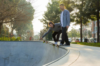 Friends skateboarding in park