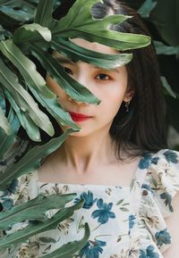 Portrait of young woman with leaves