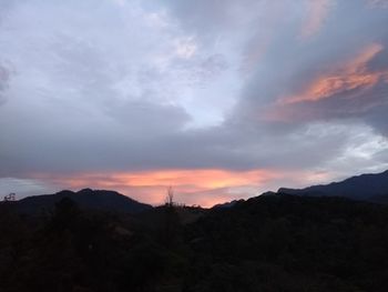 Scenic view of silhouette mountains against sky during sunset