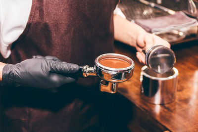 Midsection of man holding coffee cup