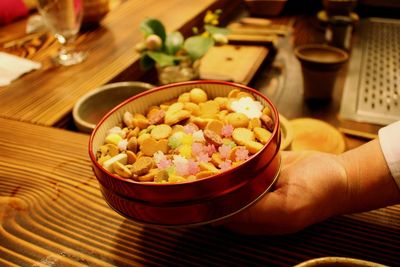 Cropped image of person holding wasanbon in container