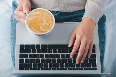 Midsection of man using laptop on table