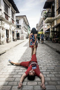 Woman dragging a man on the street