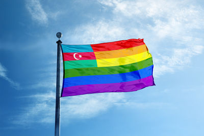 Low angle view of flags against blue sky