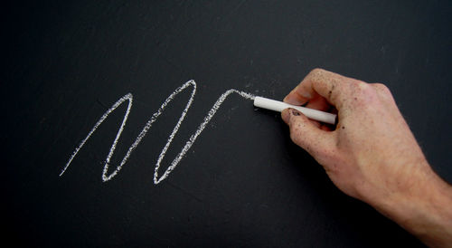 Midsection of man holding paper with text