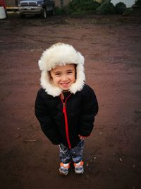 Portrait of smiling girl standing outdoors