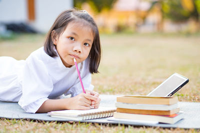 Portrait of a girl sitting on book