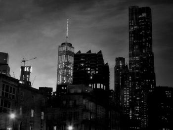 Skyscrapers in city at dusk