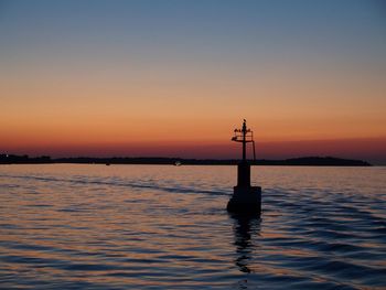 Scenic view of calm sea at sunset