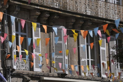 Multi colored flags hanging outside building