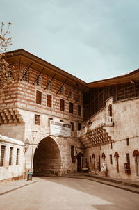 View of old building against cloudy sky