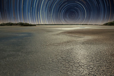 Scenic view of star trails at night