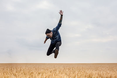 Low angle view of kite flying over field