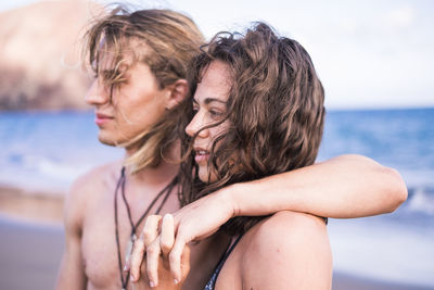 Close-up of couple embracing at beach